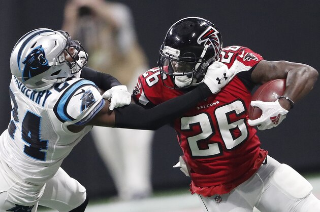 Atlanta Falcons running back Tevin Coleman (26) runs against Carolina Panthers cornerback James Bradberry (24) during the second half of an NFL football game, Sunday, Sept. 16, 2018, in Atlanta. (AP Photo/John Bazemore)