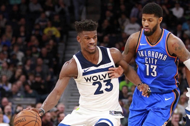 Minnesota Timberwolves forward Jimmy Butler (23) drives against Oklahoma City Thunder forward Paul George (13) in the first quarter of an NBA basketball game Wednesday, Jan. 10, 2018, in Minneapolis. The Timberwolves defeated the Thunder 104-88. (AP Photo/Andy Clayton-King)