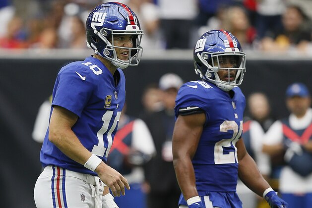 HOUSTON, TX - SEPTEMBER 23: Eli Manning #10 of the New York Giants calls out a play as Saquon Barkley #26 looks on against the Houston Texans at NRG Stadium on September 23, 2018 in Houston, Texas. (Photo by Bob Levey/Getty Images)