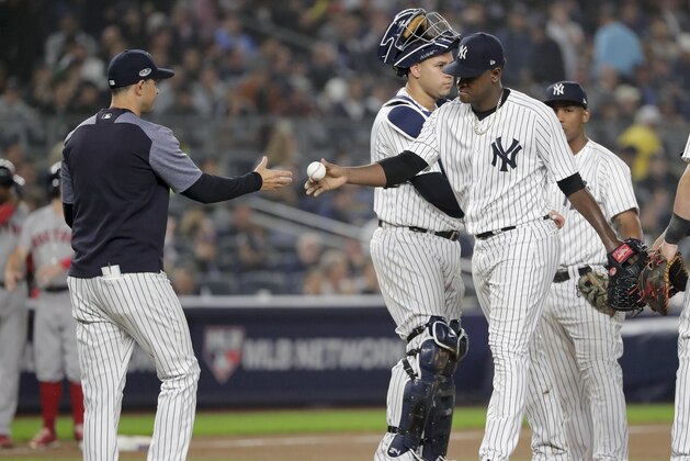 New York Yankees starting pitcher Luis Severino, right, hands the ball to manager Aaron Boone as he leaves the game during the fourth inning of Game 3 of baseball's American League Division Series against the Boston Red Sox, Monday, Oct. 8, 2018, in New York. (AP Photo/Frank Franklin II)
