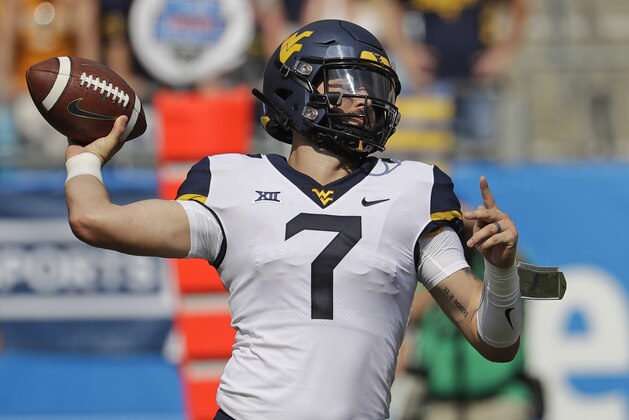 West Virginia's Will Grier (7) looks to pass against Tennessee in the first half of an NCAA college football game in Charlotte, N.C., Saturday, Sept. 1, 2018. (AP Photo/Chuck Burton)