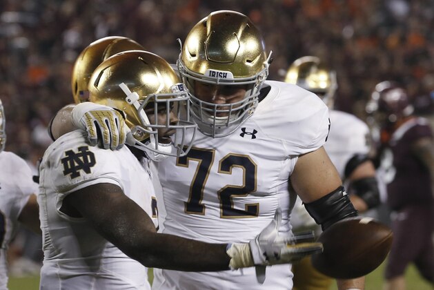 Notre Dame running back Dexter Williams, left, celebrates a touchdown with offensive lineman Robert Hainsey (72) during the second half of an NCAA college football game against Virginia Tech in Blacksburg, Va., Saturday, Oct. 6, 2018. Notre Dame won 45-23. (AP Photo/Steve Helber)