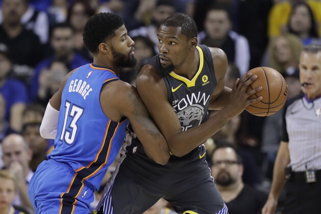Golden State Warriors' Kevin Durant is defended by Oklahoma City Thunder's Paul George (13) during the first half of an NBA basketball game Tuesday, Feb. 6, 2018, in Oakland, Calif. (AP Photo/Marcio Jose Sanchez)