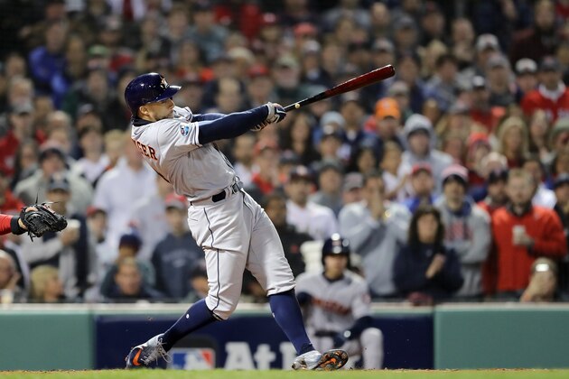BOSTON, MA - OCTOBER 13:  George Springer #4 of the Houston Astros hits a two RBI single during the second inning against the Boston Red Sox in Game One of the American League Championship Series at Fenway Park on October 13, 2018 in Boston, Massachusetts.  (Photo by Elsa/Getty Images)