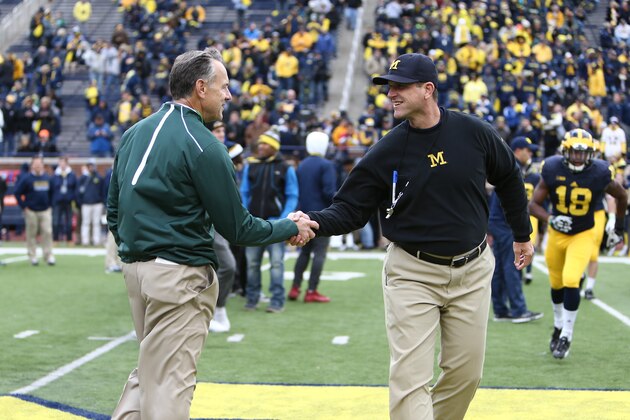 ANN ARBOR, MI - OCTOBER 17:  Head coach Mark Dantonio of the Michigan State Spartans and Head coach Jim Harbaugh of the Michigan Wolverines shake hands prior to the start of the game at Michigan Stadium on October 17, 2015 in Ann Arbor, Michigan. (Photo by Rey Del Rio)
