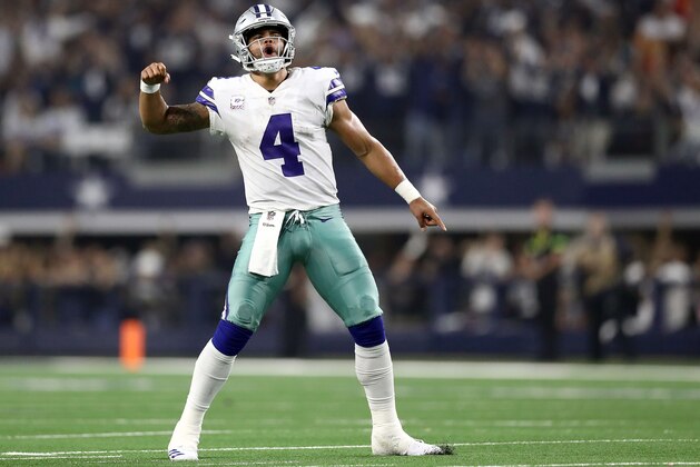 ARLINGTON, TX - OCTOBER 14:  Dak Prescott #4 of the Dallas Cowboys celebrates the fourth quarter touchdown by Ezekiel Elliott against the Jacksonville Jaguars at AT&T Stadium on October 14, 2018 in Arlington, Texas.  (Photo by Ronald Martinez/Getty Images)