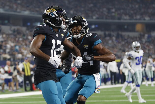 Jacksonville Jaguars wide receiver Dede Westbrook, left, celebrates his touchdown with teammate Keelan Cole, right, in the second half of an NFL football game against the Dallas Cowboys in Arlington, Texas, Sunday, Oct. 14, 2018. (AP Photo/Jim Cowsert)