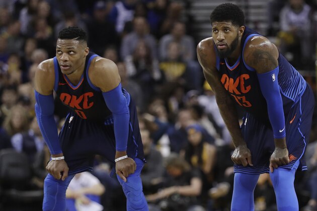Oklahoma City Thunder's Paul George, right, and Russell Westbrook during the first half of an NBA basketball game against the Golden State Warriors Saturday, Feb. 24, 2018, in Oakland, Calif. (AP Photo/Marcio Jose Sanchez)