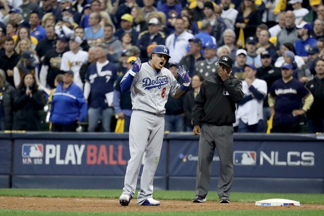 MILWAUKEE, WI - OCTOBER 12:  Manny Machado #8 of the Los Angeles Dodgers celebrates after hitting an RBI single to score Chris Taylor #3 and Joc Pederson #31 against the Milwaukee Brewers during the eighth inning in Game One of the National League Championship Series at Miller Park on October 12, 2018 in Milwaukee, Wisconsin.  (Photo by Rob Carr/Getty Images)