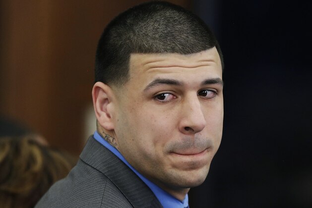 FILE - In this Friday, April 14, 2017 file photo, Former New England Patriots tight end Aaron Hernandez turns to look in the direction of the jury as he reacts to his double murder acquittal in the 2012 deaths of Daniel de Abreu and Safiro Furtado, at Suffolk Superior Court in Boston.  Dr. Ann McKee of the CTE Center at Boston University presented the findings of her examination of Hernandez's brain on Thursday, Nov. 9. McKee says she could not say that Hernandez's behavior was a result of his severe case of chronic traumatic encephalopathy. But she says Hernandez suffered substantial damage to several important parts of the brain, including the frontal lobe. Hernandez  killed himself in April, while serving life in prison for murder. (AP Photo/Stephan Savoia, Pool, File)