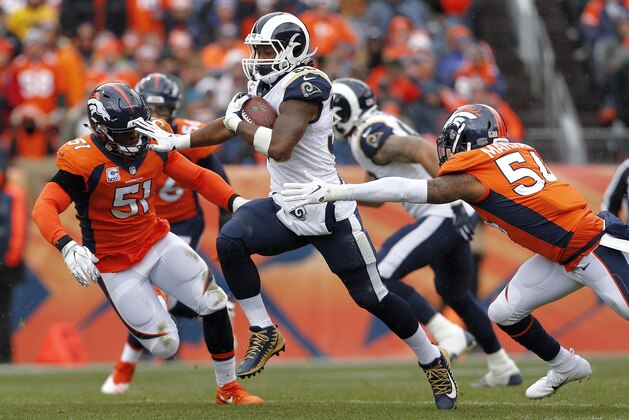Los Angeles Rams running back Todd Gurley, center, runs as Denver Broncos linebacker Brandon Marshall (54) and linebacker Todd Davis (51) pursue during the first half of an NFL football game, Sunday, Oct. 14, 2018, in Denver. (AP Photo/Joe Mahoney)