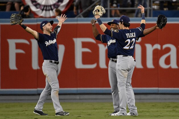 LOS ANGELES, CA - OCTOBER 15: (L-R) Ryan Braun #8, Lorenzo Cain #6  and Christian Yelich #22 of the Milwaukee Brewers celebrate after their 4-0 win in Game Three of the National League Championship Series against the Los Angeles Dodgers at Dodger Stadium on October 15, 2018 in Los Angeles, California. The Brewers defeated the Dodgers 4-0.  (Photo by Kevork Djansezian/Getty Images)