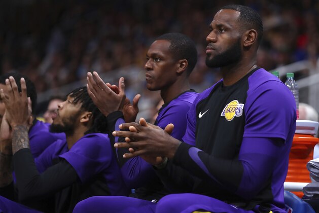 Los Angeles Lakers' LeBron James, right, claps on the bench during the first half of the team's preseason NBA basketball game against the Golden State Warriors on Friday, Oct. 12, 2018, in San Jose, Calif. (AP Photo/Ben Margot)