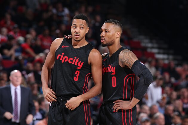 PORTLAND, OR - FEBRUARY 8:  Damian Lillard #0 speaks to CJ McCollum of the Portland Trail Blazers during the game against the Charlotte Hornets on February 8, 2018 at the Moda Center Arena in Portland, Oregon. NOTE TO USER: User expressly acknowledges and agrees that, by downloading and or using this photograph, user is consenting to the terms and conditions of the Getty Images License Agreement. Mandatory Copyright Notice: Copyright 2018 NBAE (Photo by Sam Forencich/NBAE via Getty Images)