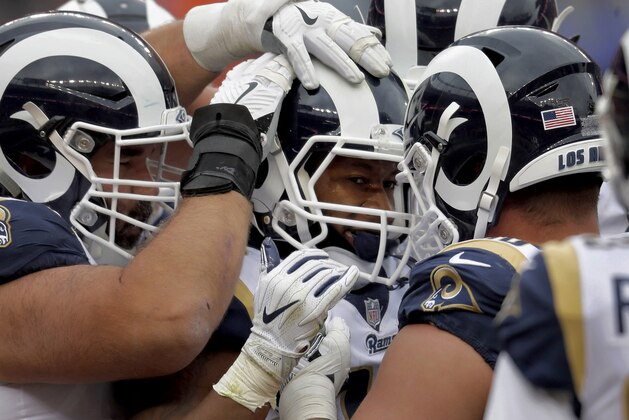 Los Angeles Rams running back Todd Gurley, center, celebrates his touchdown with teammates during the second half of an NFL football game against the Denver Broncos, Sunday, Oct. 14, 2018, in Denver. (AP Photo/David Zalubowski)