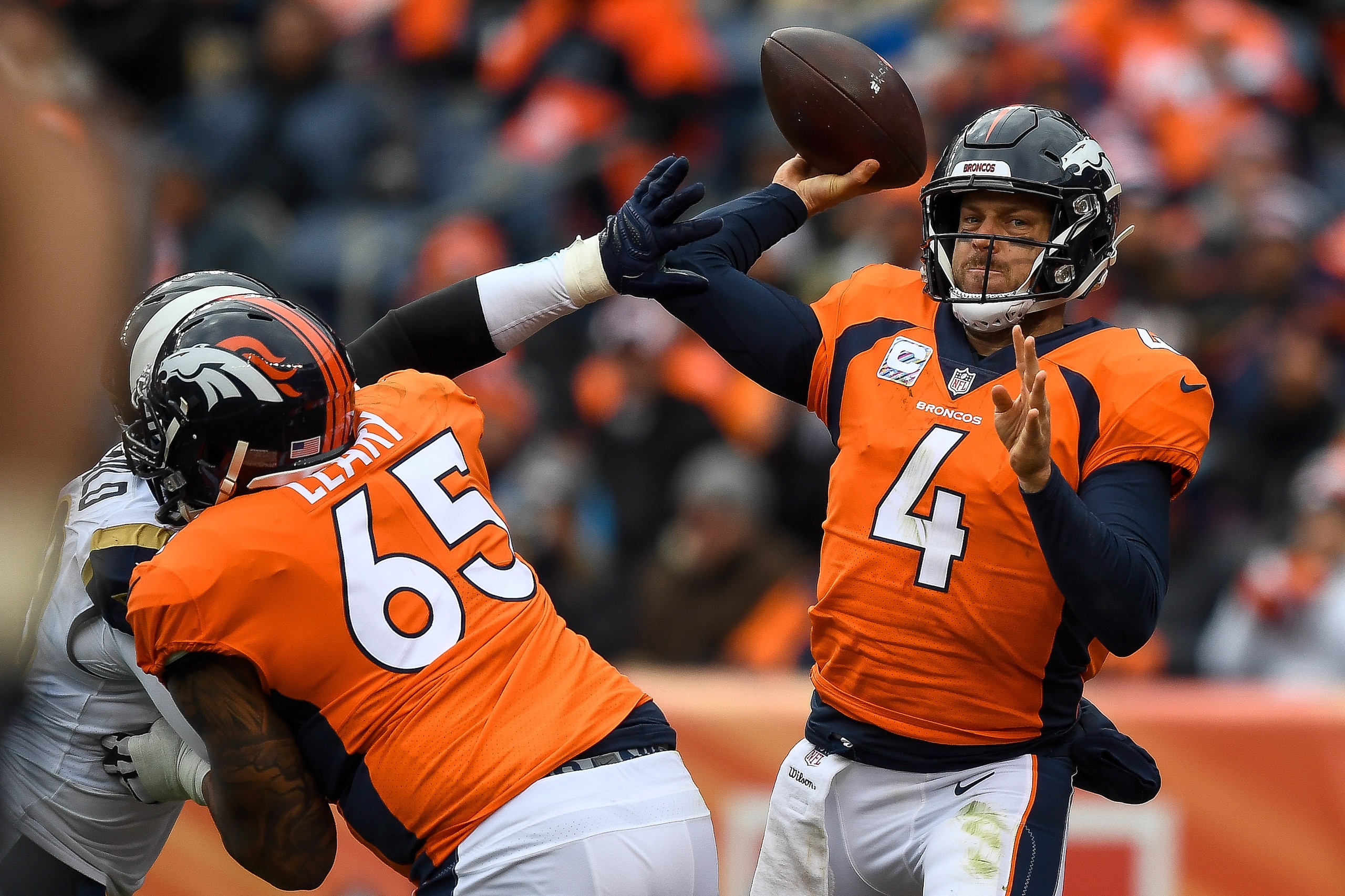 DENVER, CO - OCTOBER 14:  Quarterback Case Keenum #4 of the Denver Broncos passes under pressure in the third quarter of a game against the Los Angeles Rams at Broncos Stadium at Mile High on October 14, 2018 in Denver, Colorado. (Photo by Dustin Bradford/Getty Images)