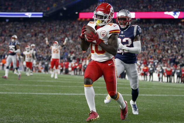 Kansas City Chiefs wide receiver Tyreek Hill catches a touchdown pass in front of New England Patriots defensive back Devin McCourty (32) during the second half of an NFL football game, Sunday, Oct. 14, 2018, in Foxborough, Mass. (AP Photo/Michael Dwyer)