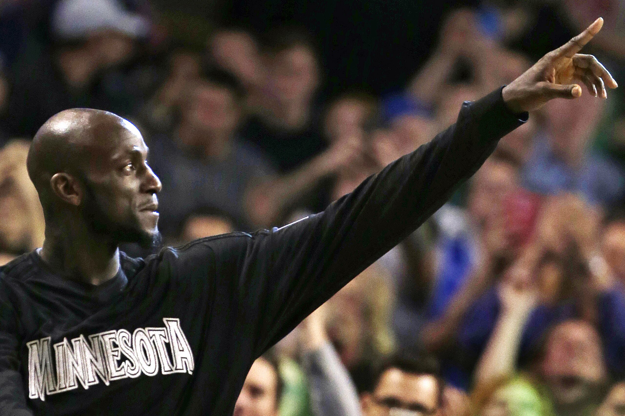 Minnesota Timberwolves forward Kevin Garnett acknowledges the crowd during a timeout in the second half of an NBA basketball game against the Boston Celtics in Boston, Monday, Dec. 21, 2015. Boston won 113-99. (AP Photo/Charles Krupa)