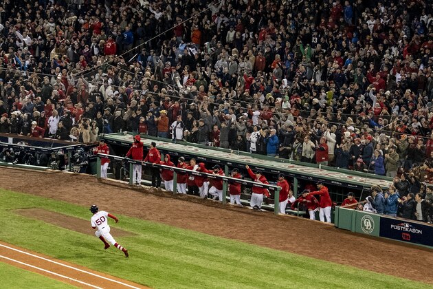 BOSTON, MA - OCTOBER 14: Mookie Betts #50 of the Boston Red Sox runs up the line after hitting an RBI double during the eighth inning of game two of the American League Championship Series against the Houston Astros on October 14, 2018 at Fenway Park in Boston, Massachusetts. (Photo by Billie Weiss/Boston Red Sox/Getty Images)