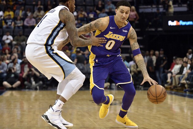 Los Angeles Lakers forward Kyle Kuzma (0) drives against Memphis Grizzlies forward Jarell Martin (1) in the first half of an NBA basketball game Saturday, March 24, 2018, in Memphis, Tenn. (AP Photo/Brandon Dill)