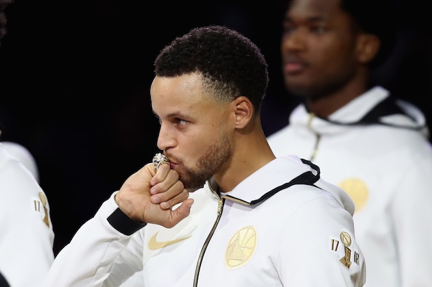 OAKLAND, CA - OCTOBER 16:  Stephen Curry #30 of the Golden State Warriors kisses his 2017-2018 Championship ring prior to their game against the Oklahoma City Thunder at ORACLE Arena on October 16, 2018 in Oakland, California.   NOTE TO USER: User expressly acknowledges and agrees that, by downloading and or using this photograph, User is consenting to the terms and conditions of the Getty Images License Agreement.  (Photo by Ezra Shaw/Getty Images)
