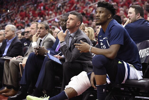 Minnesota Timberwolves guard Jimmy Butler, right, watches from the bench during the second half in Game 5 of the team's first-round NBA basketball playoff series against the Houston Rockets, Wednesday, April 25, 2018, in Houston. (AP Photo/Eric Christian Smith)