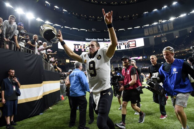 New Orleans Saints quarterback Drew Brees (9) acknowledges the crowd as he runs off the field after an NFL football game against the Washington Redskins in New Orleans, Monday, Oct. 8, 2018. Brees broke the NFL all-time passing yards record during the game. The Saints won 43-19. (AP Photo/Bill Feig)