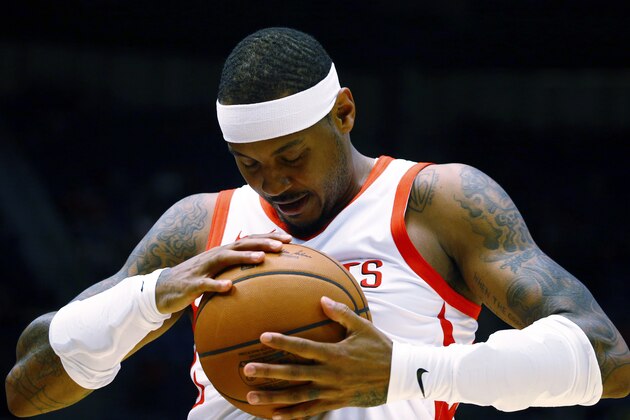 Houston Rockets forward Carmelo Anthony (7) rubs the ball before the start of the game against the Memphis Grizzlies during the first half of a preseason NBA basketball game, Tuesday, Oct. 2, 2018, in Birmingham, Ala. (AP Photo/Butch Dill)
