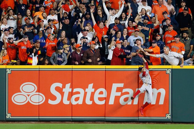 HOUSTON, TX - OCTOBER 17:  A fan interferes with Mookie Betts #50 of the Boston Red Sox as he attempts to catch a ball hit by Jose Altuve #27 of the Houston Astros (not pictured) in the first inning during Game Four of the American League Championship Series at Minute Maid Park on October 17, 2018 in Houston, Texas.  (Photo by Bob Levey/Getty Images)
