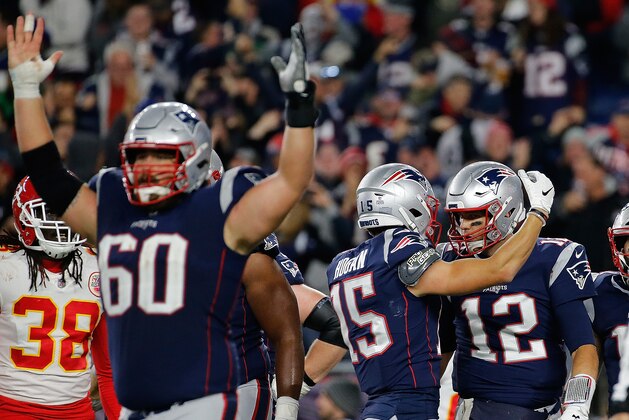 FOXBOROUGH, MA - OCTOBER 14: Tom Brady #12 of the New England Patriots his touchdown with Chris Hogan #15 of the New England Patriots in the fourth quarter against the Kansas City Chiefs at Gillette Stadium on October 14, 2018 in Foxborough, Massachusetts. (Photo by Jim Rogash/Getty Images)