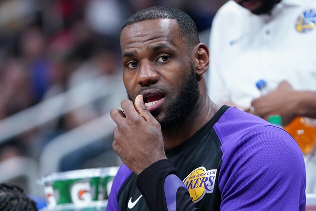 SAN JOSE, CA - OCTOBER 12:  LeBron James #23 of the Los Angeles Lakers looks on from the bench while eating grapes against the Golden State Warriors during the first half of their NBA preseason basketball game at SAP Center on October 12, 2018 in San Jose, California. NOTE TO USER: User expressly acknowledges and agrees that, by downloading and or using this photograph, User is consenting to the terms and conditions of the Getty Images License Agreement.  (Photo by Thearon W. Henderson/Getty Images)