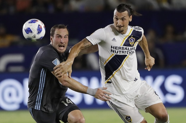 LA Galaxy forward Zlatan Ibrahimovic, right, is defended by Minnesota United defender Brent Kallman during the first half of an MLS soccer match Saturday, Aug. 11, 2018, in Carson, Calif. (AP Photo/Marcio Jose Sanchez)