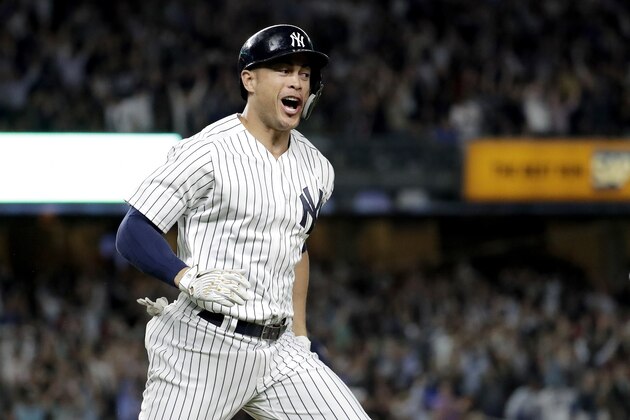 New York Yankees' Giancarlo Stanton reacts after hitting a grand slam off Boston Red Sox relief pitcher Heath Hembree during the fourth inning of a baseball game Thursday, Sept. 20, 2018, in New York. (AP Photo/Julio Cortez)