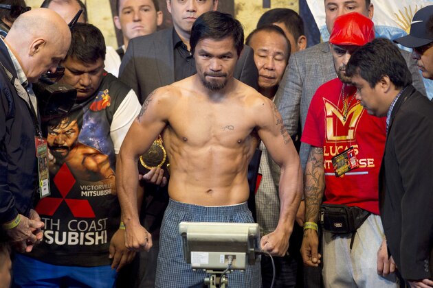 Philippine senator and boxing hero Manny Pacquiao, center, poses during weigh-in in Kuala Lumpur, Malaysia, Saturday, July 14, 2018. Matthysse and Pacquiao were scheduled to fight on July 15, for the World Boxing Association welterweight title in Malaysia. (AP Photo/Yam G-Jun)