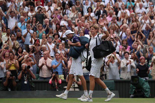South Africa's Kevin Anderson (R) and US player John Isner leave following the final set tie-break of their men's singles semi-final match on the eleventh day of the 2018 Wimbledon Championships at The All England Lawn Tennis Club in Wimbledon, southwest London, on July 13, 2018. - Anderson won the match 7-6, 6-7, 6-7, 6-4, 26-24. (Photo by Daniel LEAL-OLIVAS / AFP) / RESTRICTED TO EDITORIAL USE        (Photo credit should read DANIEL LEAL-OLIVAS/AFP/Getty Images)