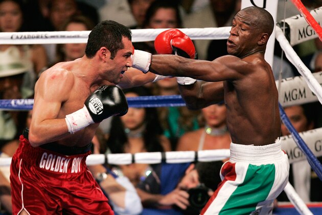 Oscar De La Hoya, left, and Floyd Mayweather Jr. trade blows during the third round of their WBC super welterweight world championship boxing match on Saturday, May 5, 2007, at the MGM Grand Garden Arena  in Las Vegas. (AP Photo/Eric Jamison)