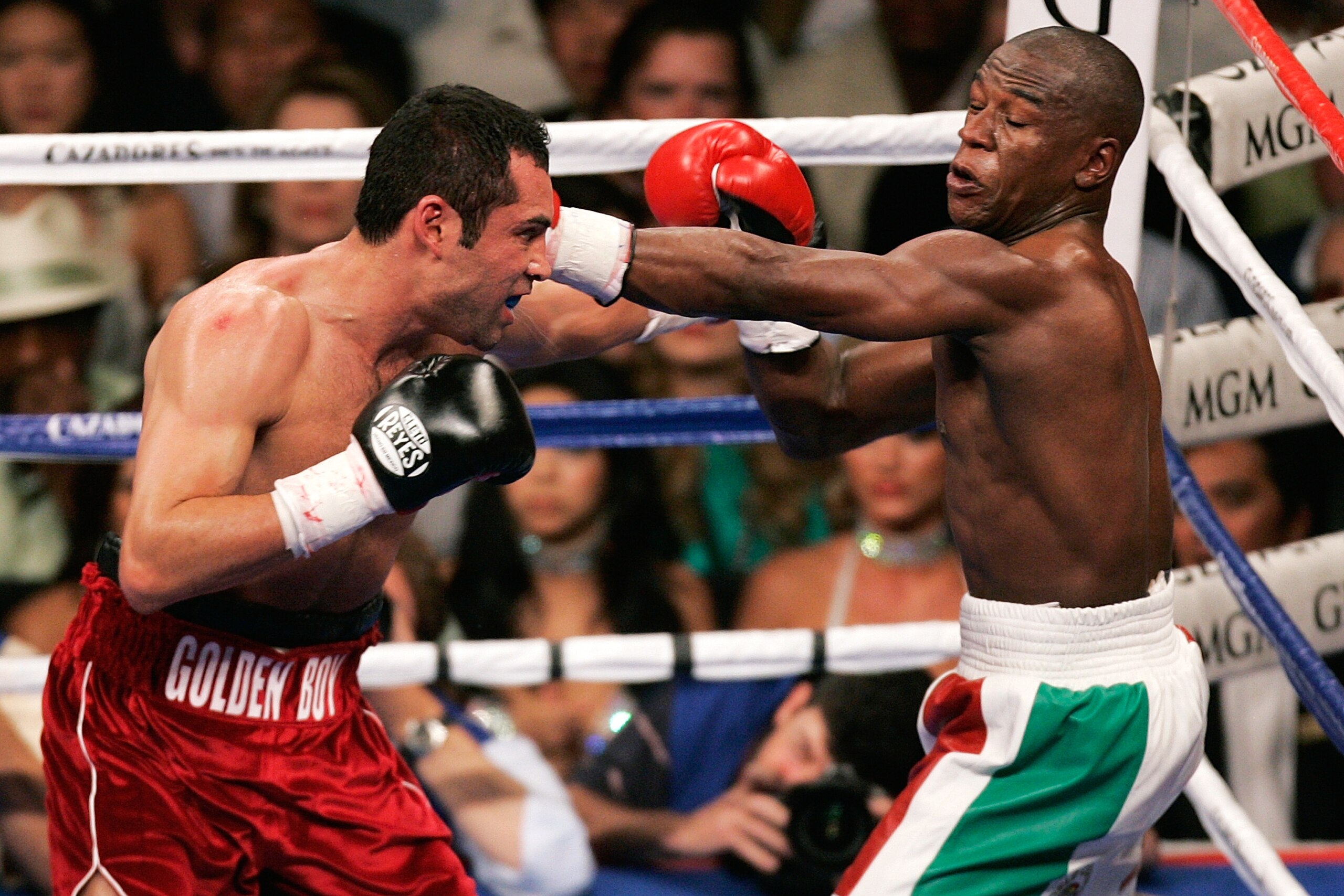 Oscar De La Hoya, left, and Floyd Mayweather Jr. trade blows during the third round of their WBC super welterweight world championship boxing match on Saturday, May 5, 2007, at the MGM Grand Garden Arena  in Las Vegas. (AP Photo/Eric Jamison)