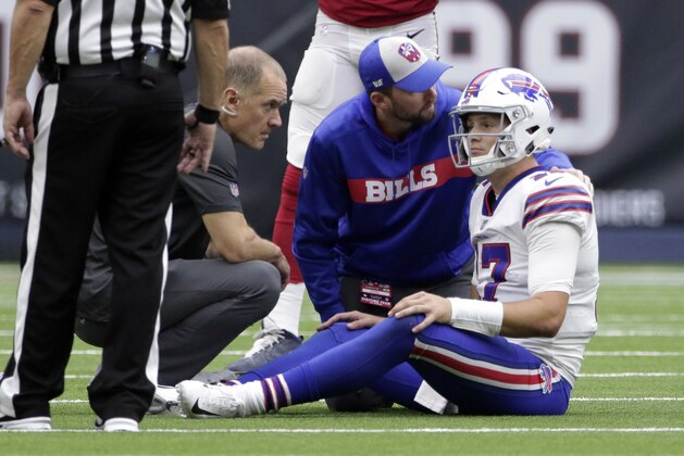 Buffalo Bills quarterback Josh Allen (17) is check on after he was injured during the second half of an NFL football game against the Houston Texans, Sunday, Oct. 14, 2018, in Houston. (AP Photo/Michael Wyke)