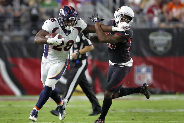 Denver Broncos running back Royce Freeman (28) stiff arms Arizona Cardinals defensive back Bene' Benwikere (23) during the first half of an NFL football game, Thursday, Oct. 18, 2018, in Glendale, Ariz. (AP Photo/Ralph Freso)
