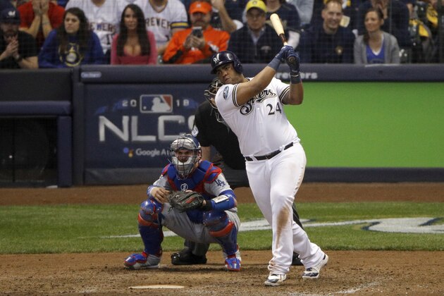 Milwaukee Brewers' Jesus Aguilar (24) hits an RBI single during the eighth inning of Game 6 of the National League Championship Series baseball game against the Los Angeles Dodgers Friday, Oct. 19, 2018, in Milwaukee. (AP Photo/Charlie Riedel)