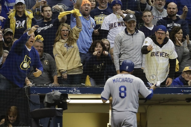 Fans scream after Los Angeles Dodgers' Manny Machado struck out during the first inning of Game 6 of the National League Championship Series baseball game against the Milwaukee Brewers Friday, Oct. 19, 2018, in Milwaukee. (AP Photo/Matt Slocum)