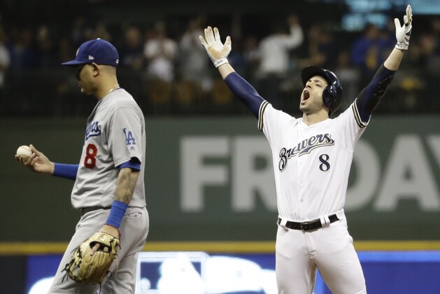 Milwaukee Brewers' Ryan Braun reacts after hitting an RBI double during the second inning of Game 6 of the National League Championship Series baseball game against the Los Angeles Dodgers Friday, Oct. 19, 2018, in Milwaukee. (AP Photo/Matt Slocum)