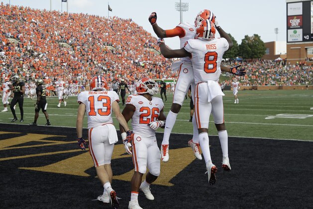 Clemson's Travis Etienne, back, celebrates his touchdown run with Justyn Ross (8) during the first half of an NCAA college football game against Wake Forest in Charlotte, N.C., Saturday, Oct. 6, 2018. (AP Photo/Chuck Burton)