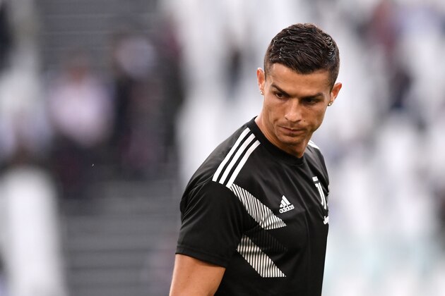 Juventus' Portuguese forward Cristiano Ronaldo looks on as he warms up prior to the Italian Serie A football match Juventus vs Genoa on October 20, 2018 at the Juventus Allianz stadium in Turin. (Photo by Marco BERTORELLO / AFP)        (Photo credit should read MARCO BERTORELLO/AFP/Getty Images)