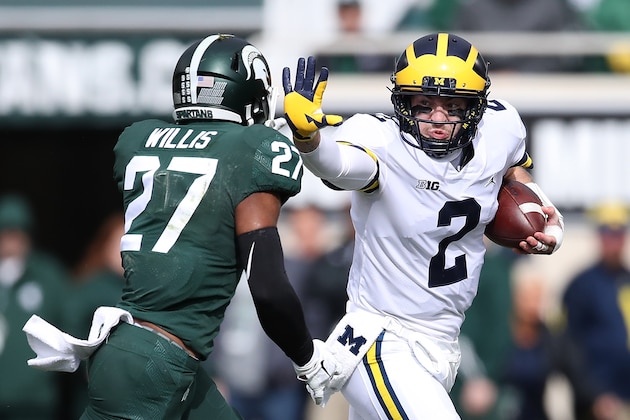 EAST LANSING, MI - OCTOBER 20: Shea Patterson #2 of the Michigan Wolverines tries to get around the tackle of Khari Willis #27 of the Michigan State Spartans during a first quarter run at Spartan Stadium on October 20, 2018 in East Lansing, Michigan. (Photo by Gregory Shamus/Getty Images)