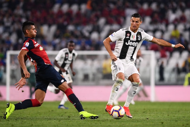Juventus' Portuguese forward Cristiano Ronaldo (R) controls the ball under pressure from Genoa's Argentine defender, Cristian Romero during the Italian Serie A football match Juventus vs Genoa on October 20, 2018 at the Juventus Allianz stadium in Turin. (Photo by Marco BERTORELLO / AFP)        (Photo credit should read MARCO BERTORELLO/AFP/Getty Images)