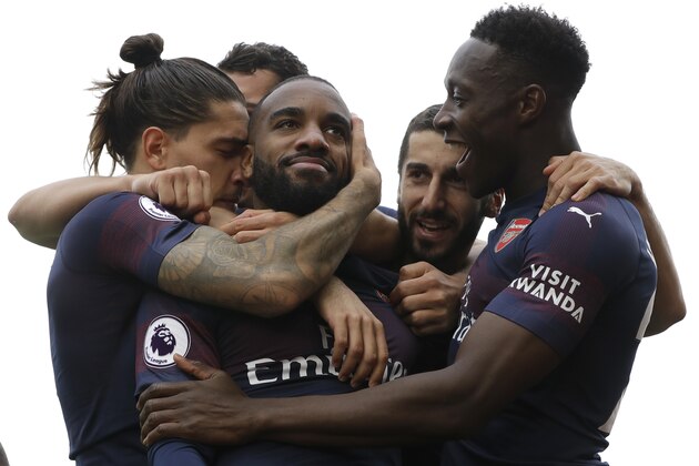Arsenal's Alexandre Lacazette, centre, celebrates scoring his side's second goal during the English Premier League soccer match between Fulham and Arsenal at Craven Cottage stadium in London, Sunday, Oct. 7, 2018. (AP Photo/Kirsty Wigglesworth)