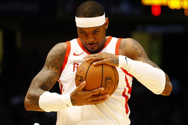 Houston Rockets forward Carmelo Anthony (7) rubs the ball before the start of the game against the Memphis Grizzlies during the first half of a preseason NBA basketball game, Tuesday, Oct. 2, 2018, in Birmingham, Ala. (AP Photo/Butch Dill)