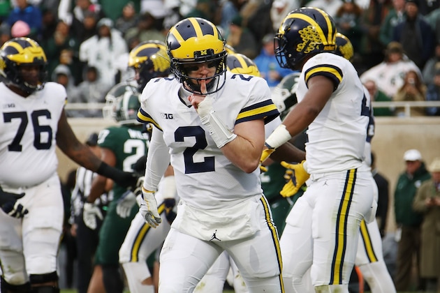 EAST LANSING, MI - OCTOBER 20:  Shea Patterson #2 of the Michigan Wolverines reacts to a teammates second quarter touchdown while playing the Michigan State Spartans at Spartan Stadium on October 20, 2018 in East Lansing, Michigan. (Photo by Gregory Shamus/Getty Images)