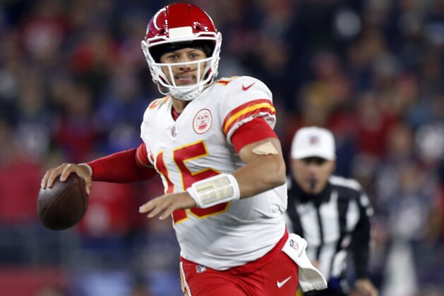 Kansas City Chiefs quarterback Patrick Mahomes rolls out to pass against the New England Patriots during the first half of an NFL football game, Sunday, Oct. 14, 2018, in Foxborough, Mass. (AP Photo/Michael Dwyer)